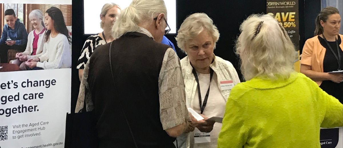 A lady talking to people at an event