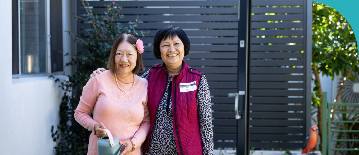 A younger woman, an older woman and a younger man all looking at the camera and smiling