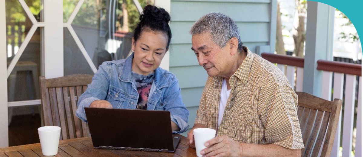 A man and a woman looking at a laptop